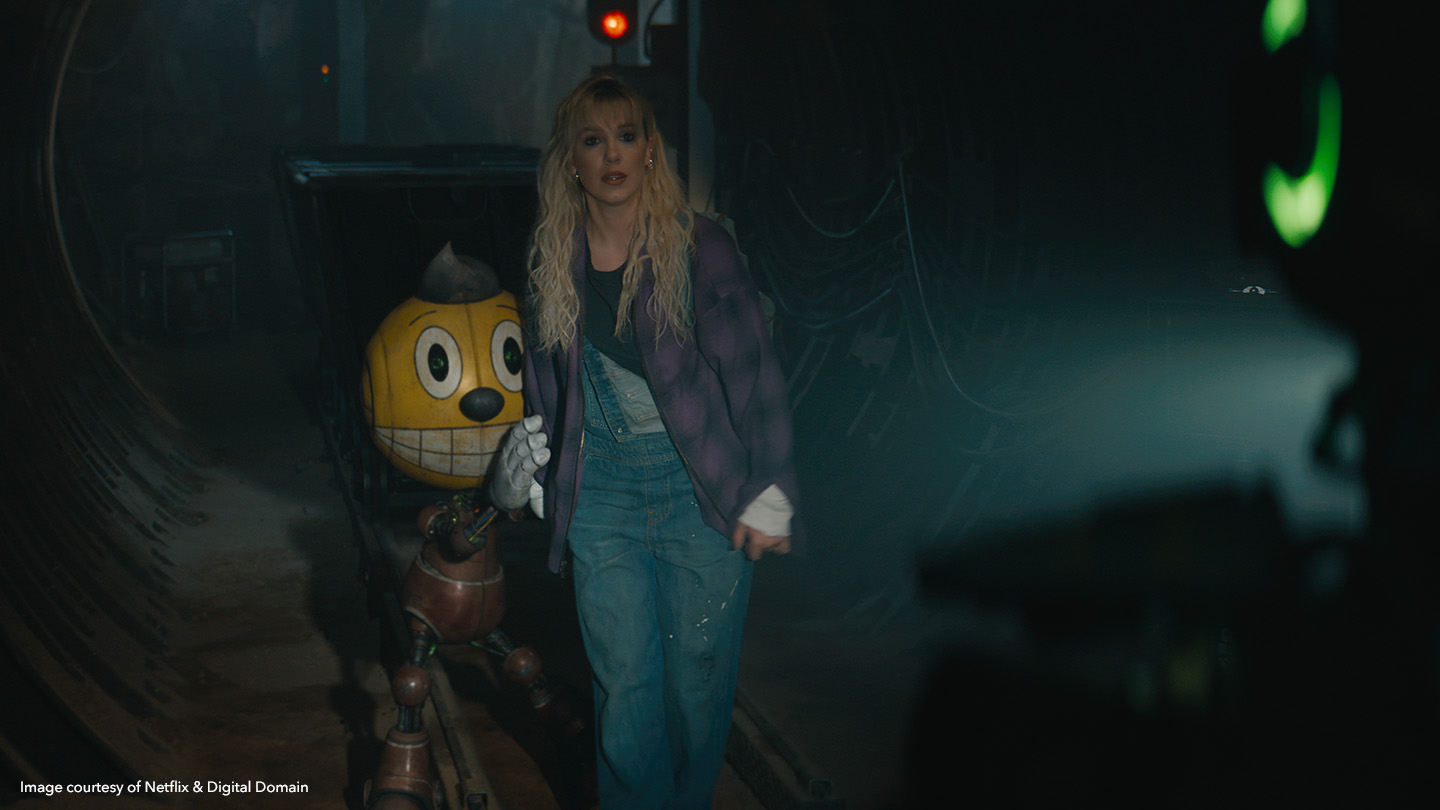 Millie Bobby Brown as Michelle Greene walking with Cosmo the robot in The Electric State