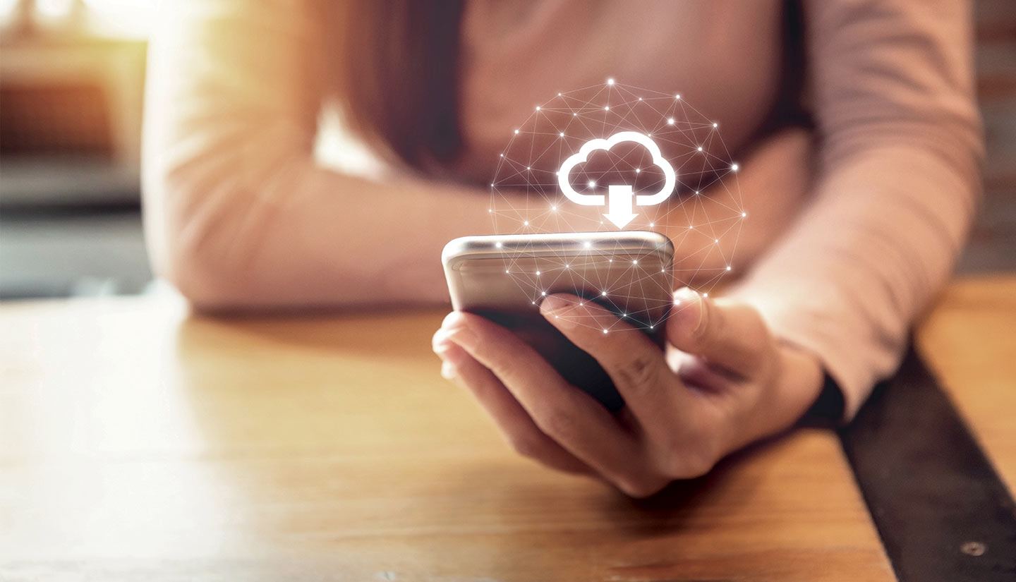 Woman holding iPhone with Cloud icon