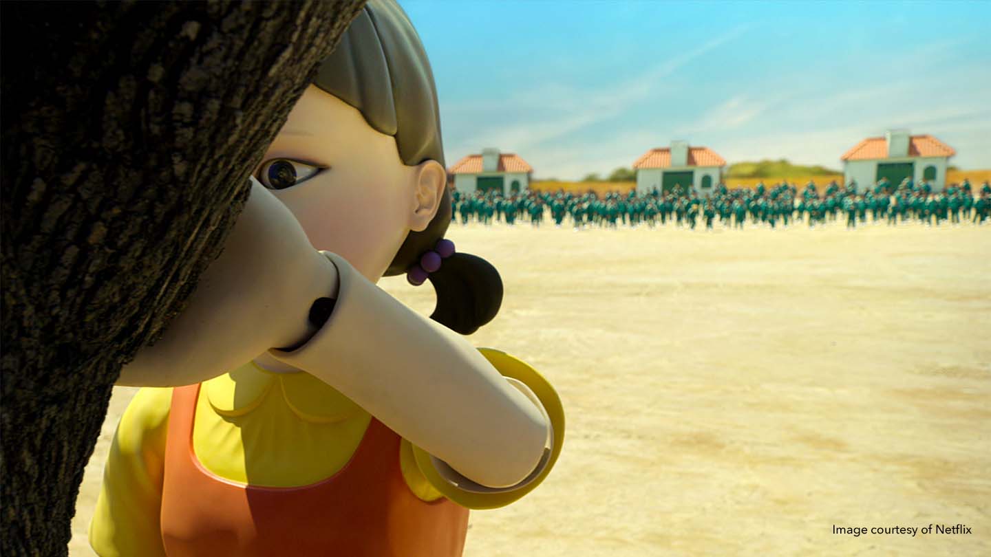 A computer-generated image of a scene from Squid Game, which was produced by Gulliver Studios, using Nuke. The image shows a close-up of a girl seemingly counting by a tree with an army of people in the distance.